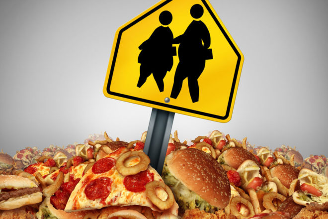 Children Diet Problems And Obesity Crisis In The School Concept As A Heap Of Unhealthy Fast Food With Two Overweight Fat Kids On A A Crossing Traffic