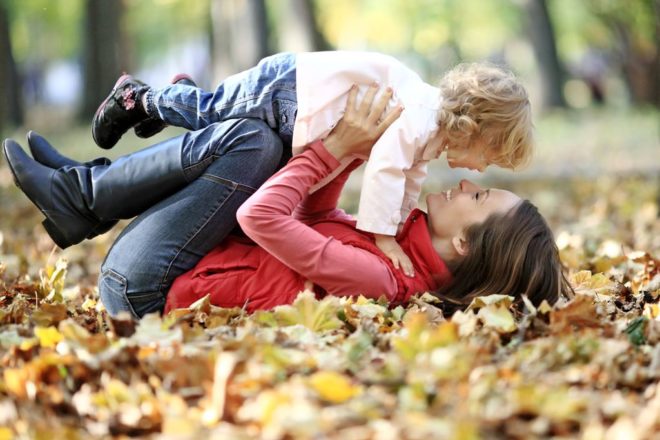 Happy Family Having Fun In Autumn Park