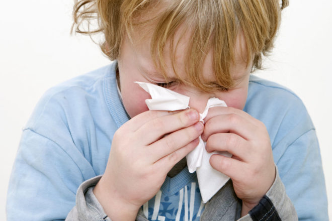 Young Boy Sneezing In A Handkerchief Square Close Up